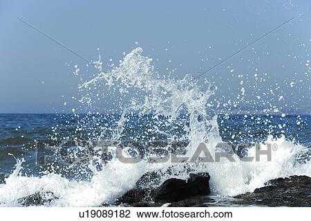 Waves breaking on rocks View Large Photo Image Stock Image - Waves breaking on rocks. Fotosearch