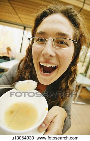 Stock Image - Woman eats soup. Fotosearch