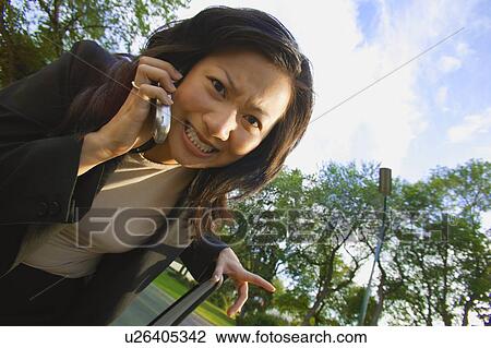 Stock Image - Woman has a stressful conversation. Fotosearch