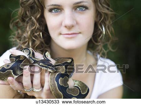 Woman holding a snake View Large Photo Image Stock Image - Woman holding a snake. Fotosearch