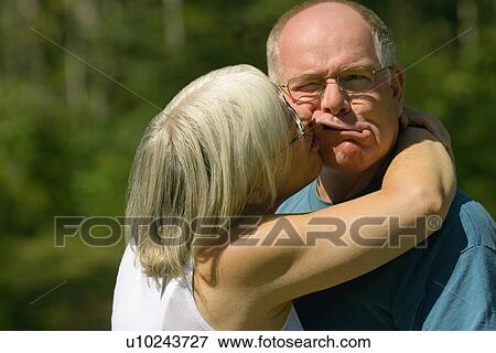 Woman kissing a man View Large Photo Image Stock Photo - Woman kissing a man. Fotosearch