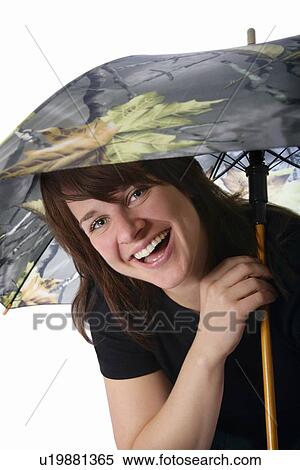 Woman laughing with an umbrella View Large Photo Image Stock Photography - Woman laughing with an umbrella. Fotosearch