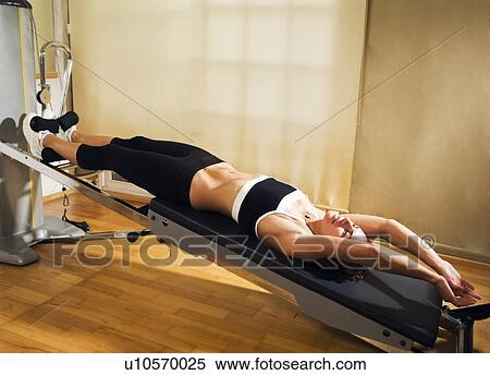 Stock Photography - Woman on exercise machine . Fotosearch