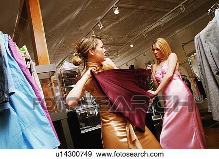Stock Photo - Women fighting over clothes. Fotosearch