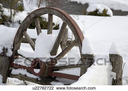 Stock Image - Wooden carriage covered in snow. Fotosearch