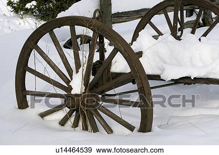 Stock Photo - Wooden carriage covered in snow. Fotosearch