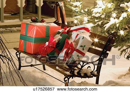 Wrapped presents sitting on a park bench outside View Large Photo Image Stock Photo - Wrapped presents sitting on a park bench outside. Fotosearch