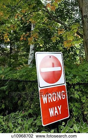 Stock Image - Wrong Way sign in middle of woods, Muskoka, Ontario, Canada. Fotosearch