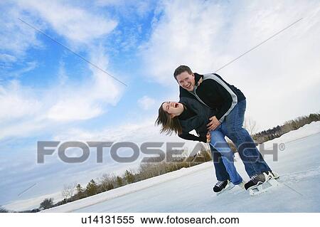 Young Couple Having fun on skates View Large Photo Image Stock Photography - Young Couple Having fun on skates. Fotosearch