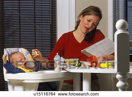 Picture - Young mother working from home. Fotosearch