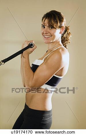 Young woman training in gym View Large Photo Image Stock Image - Young woman training in gym . Fotosearch