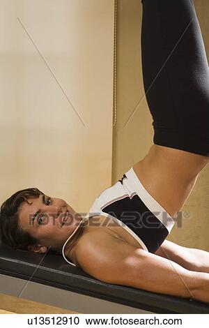 Young woman working out View Large Photo Image Stock Image - Young woman working out. Fotosearch