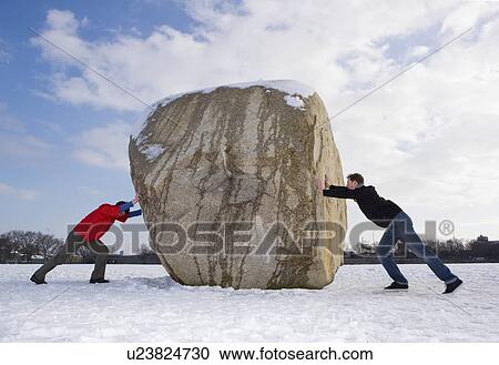 Stock Image - 2 men pushing boulder. Fotosearch