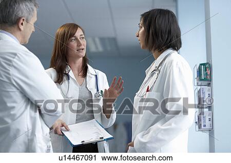 Stock Image - 3 doctors in discussion. Fotosearch