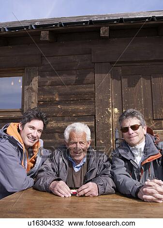3 men sitting at table smiling View Large Photo Image Stock Image - 3 men sitting at table smiling. Fotosearch
