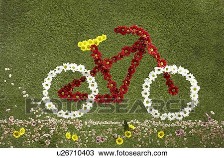 Stock Image - A bike made out of flowers set on grass. Fotosearch