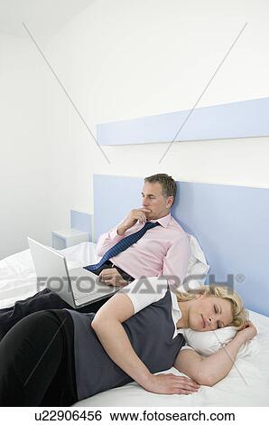 A business couple in bed View Large Photo Image Stock Photograph - A business couple in bed. Fotosearch