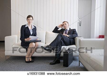 A business couple waiting in reception View Large Photo Image Stock Photo - A business couple waiting in reception. Fotosearch