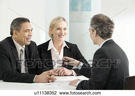 Stock Image - A business discussion. Fotosearch