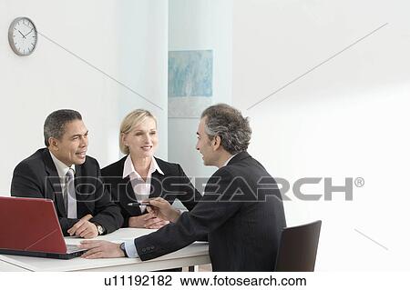 A business discussion with laptop View Large Photo Image Stock Image - A business discussion with laptop. Fotosearch