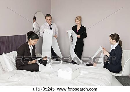 A business foursome read computer paper View Large Photo Image Stock Photography - A business foursome read computer paper. Fotosearch