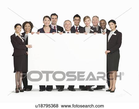 A business group holding a white board View Large Photo Image Stock Photo - A business group holding a white board. Fotosearch