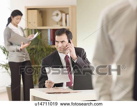 Stock Photo - A business man at the office. Fotosearch