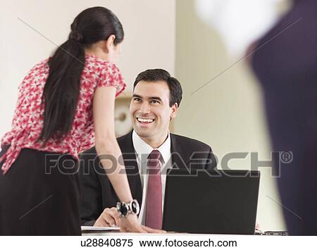 A business man talking to a colleague View Large Photo Image Stock Photography - A business man talking to a colleague. Fotosearch