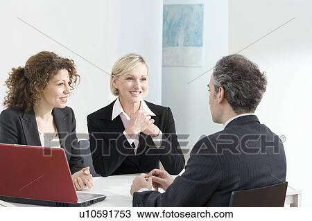 A business meeting with a red laptop View Large Photo Image Stock Image - A business meeting with a red laptop. Fotosearch