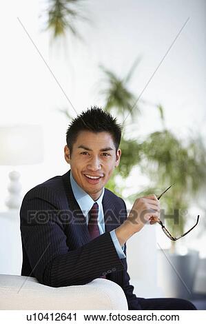 A businessman looking to camera View Large Photo Image Stock Image - A businessman looking to camera. Fotosearch