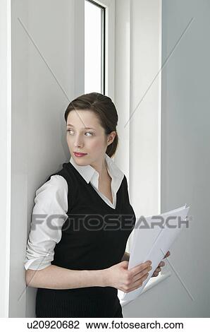 A businesswoman looking out of a window View Large Photo Image Stock Image - A businesswoman looking out of a window. Fotosearch