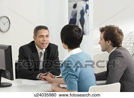 A couple meet with a business manager View Large Photo Image Stock Image - A couple meet with a business manager. Fotosearch