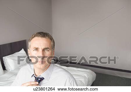A man adjusting his tie View Large Photo Image Picture - A man adjusting his tie. Fotosearch