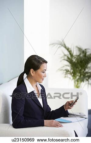 A senior asian businesswoman texting View Large Photo Image Stock Photo - A senior asian businesswoman texting. Fotosearch