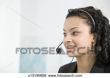 A telephone operator talking into a mic View Large Photo Image Stock Photo - A telephone operator talking into a mic. Fotosearch