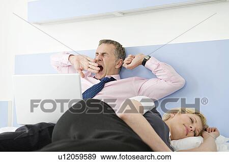 A tired business couple in bed View Large Photo Image Stock Photo - A tired business couple in bed. Fotosearch