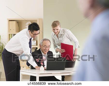 An informal office meeting View Large Photo Image Stock Photo - An informal office meeting. Fotosearch