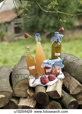 Apples and juice on log pile View Large Photo Image Stock Photo - Apples and juice on log pile. Fotosearch