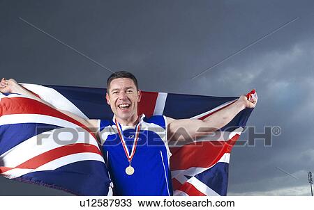 athlete cheering with U. K. flag and medal View Large Photo Image Stock Image - athlete cheering with U. K. flag and medal. Fotosearch