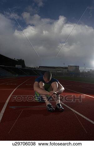 athlete sitting on track View Large Photo Image Stock Photo - athlete sitting on track. Fotosearch