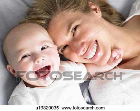 Baby and mother on bed, shot from above View Large Photo Image Stock Photography - Baby and mother on bed, shot from above. Fotosearch