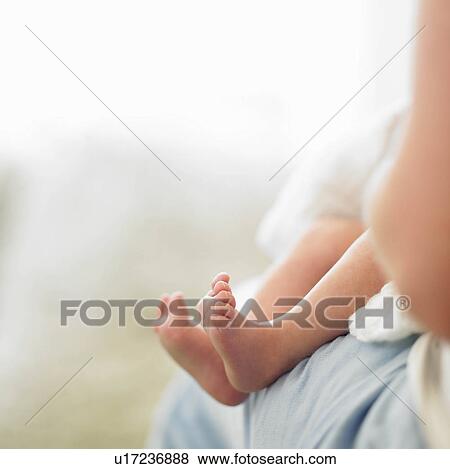 Baby feet on mother's lap View Large Photo Image Stock Photo - Baby feet on mother's lap. Fotosearch
