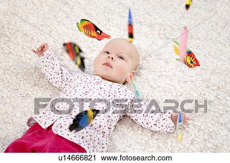 baby lying beneath mobile toy View Large Photo Image Stock Image - baby lying beneath mobile toy. Fotosearch