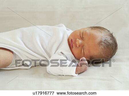 Baby lying on back sleeping View Large Photo Image Stock Photo - Baby lying on back sleeping. Fotosearch