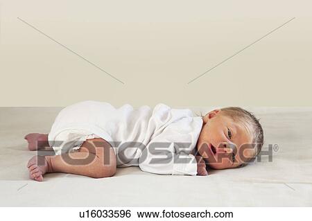Baby lying on stomach View Large Photo Image Stock Photograph - Baby lying on stomach. Fotosearch