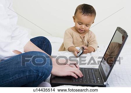 baby on bed View Large Photo Image Picture - baby on bed. Fotosearch