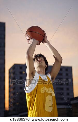 Stock Photograph - basketball player taking shot. Fotosearch