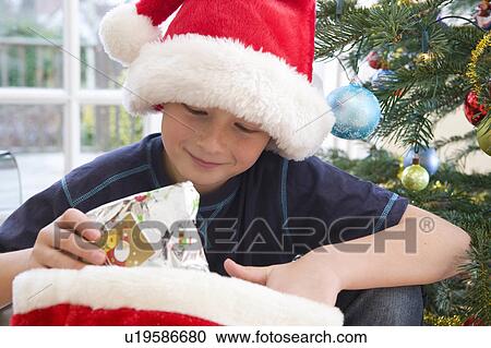 Stock Image - Boy, 10 holding present. Fotosearch