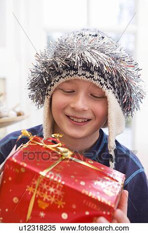 Boy, 10 holding present View Large Photo Image Stock Photography - Boy, 10 holding present. Fotosearch