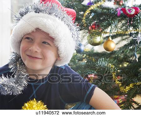 Boy, 10 with Christmas decorations View Large Photo Image Stock Image - Boy, 10 with Christmas decorations. Fotosearch